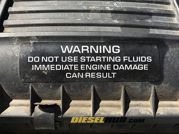 Starting fluid warning label on a 12v Cummins engine air cleaner assembly