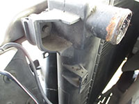 Driver side radiator mounting bolt