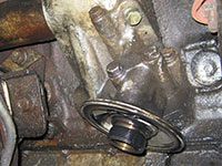 Removing rear oil cooler header bolts